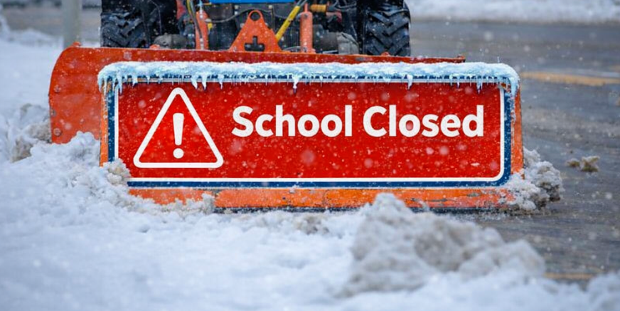 a snowplow with the words school closed as a sign on the plow