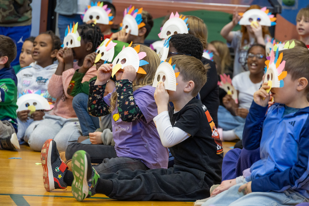Students wear handmade bird masks to recognize Bethany Connolly's recognition as Administrator of the Year from the Maine Association of School Libraries