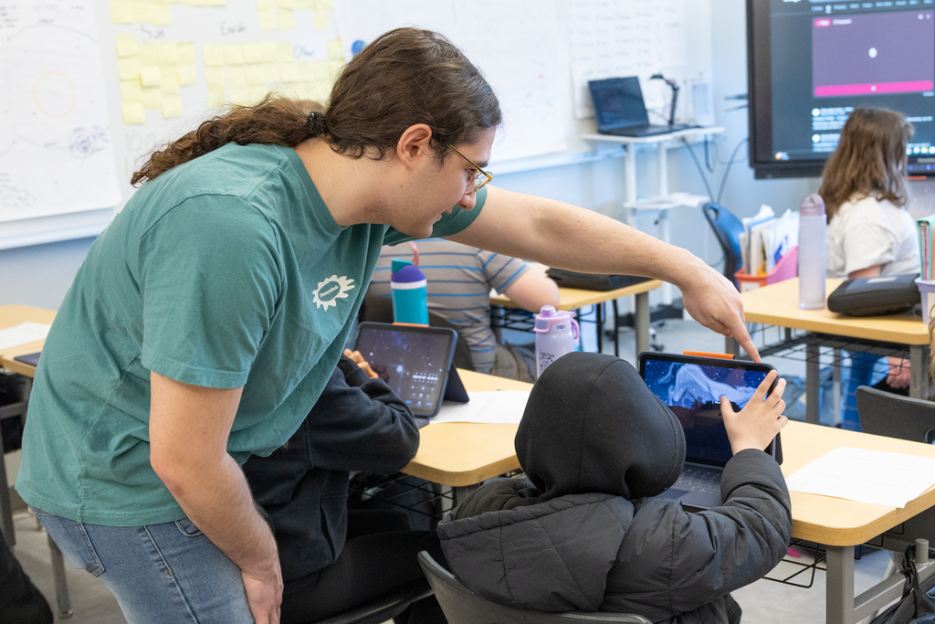 Students using their devices to track constellations throughout the year.