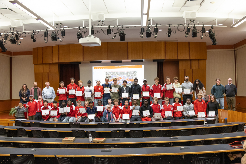 A group photo of the Board and the Boys Indoor Track Team.