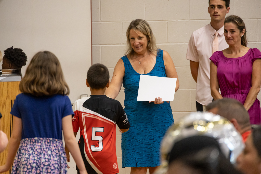 Skillin Elementary students walk the halls as other grades cheer them on before receiving their certificates for completing fourth grade.