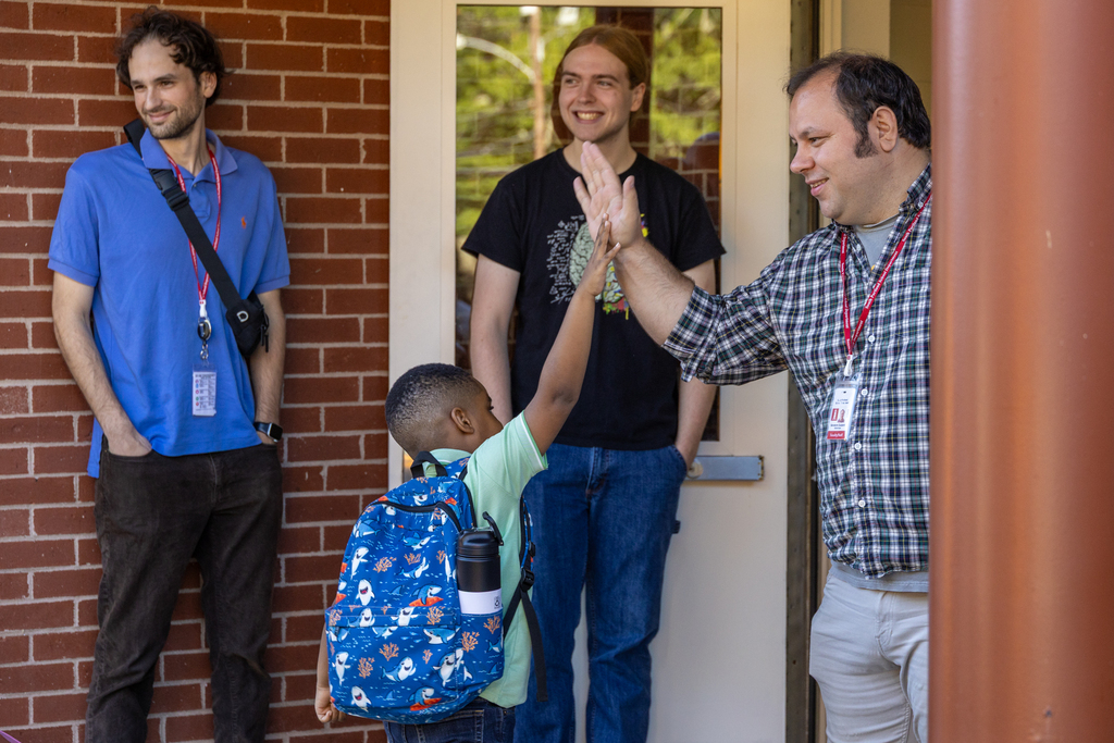Student high-fiving staff member at Skillin Elementary