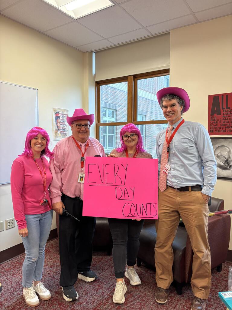 SPHS leaders dressed up in pink with sign that reads "Every day counts."
