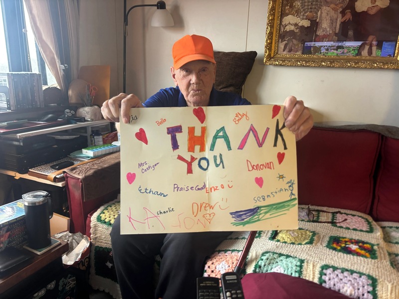 Tom Schmaling with a sign that some students made for him. (Dana Richie/Staff Writer)