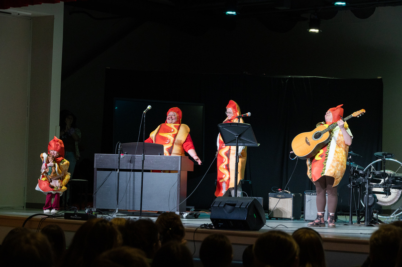SPMS Talent Show & Fundraiser - staff members performing music while wearing hot dog costumes