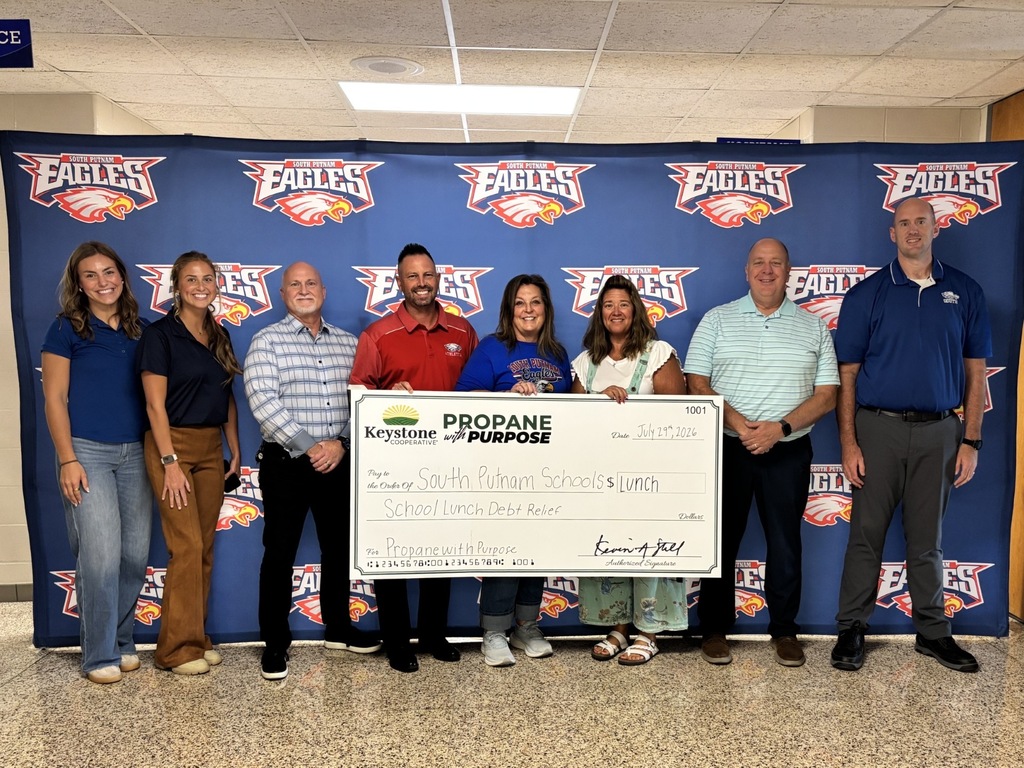 administrators holding big check