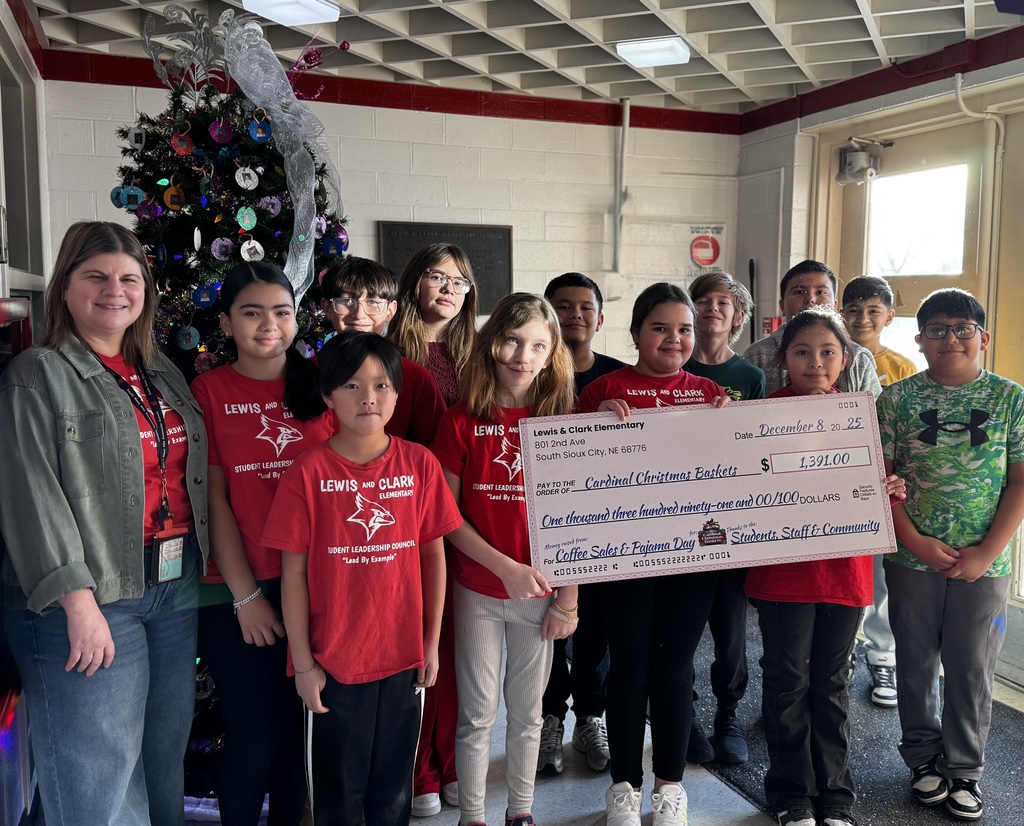 lewis and clark students holding the check for the cardinal christmas baskets donation