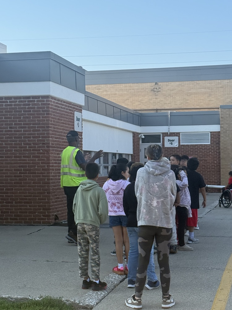 students practicing bus safety evacuation procedures 