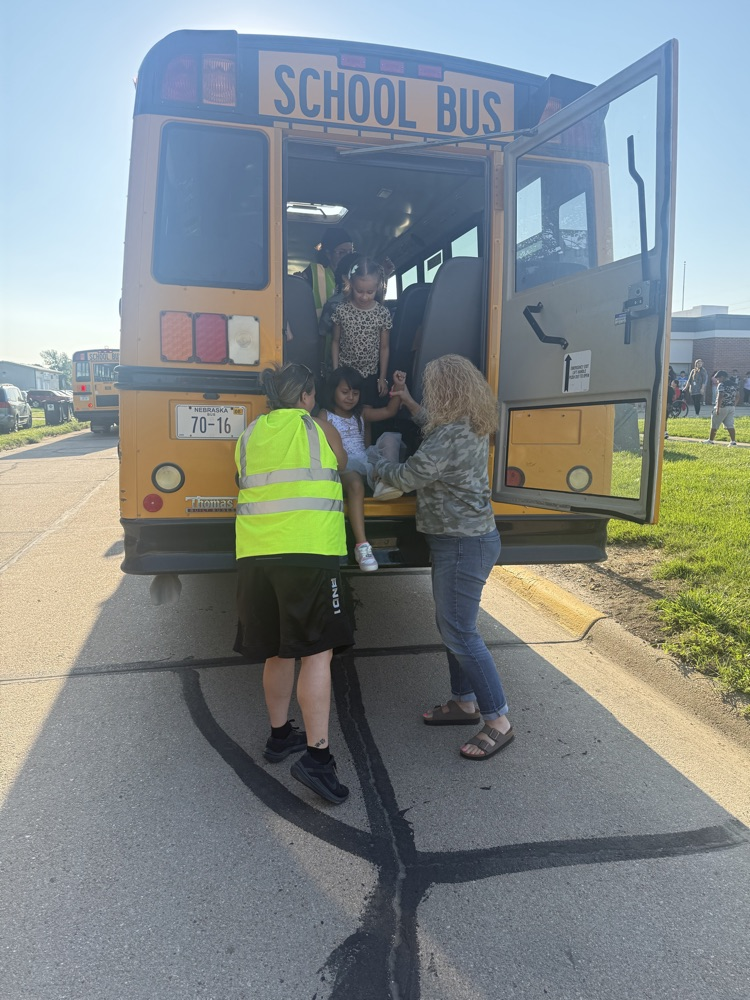students practicing bus safety evacuation procedures 