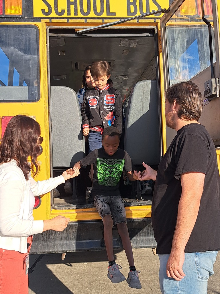 students on a school bus practicing bus safety skills