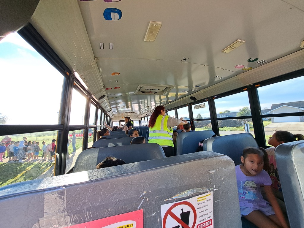 students on a school bus practicing bus safety skills