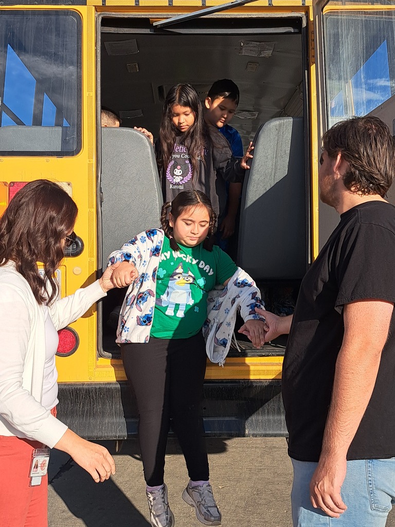 students on a school bus practicing bus safety skills