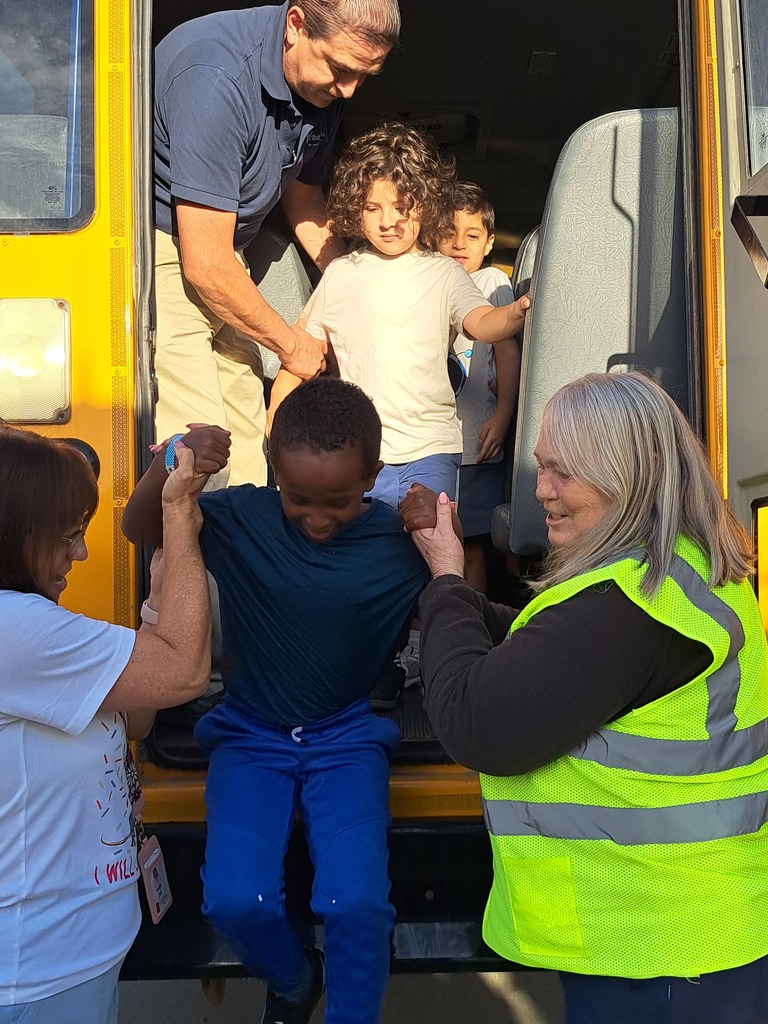 students on a school bus practicing bus safety skills
