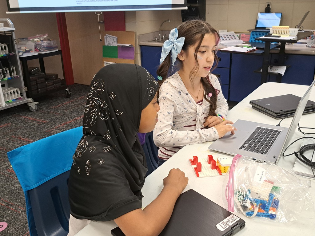 students working together to build Lego