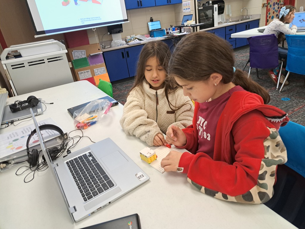 students working together to build Lego