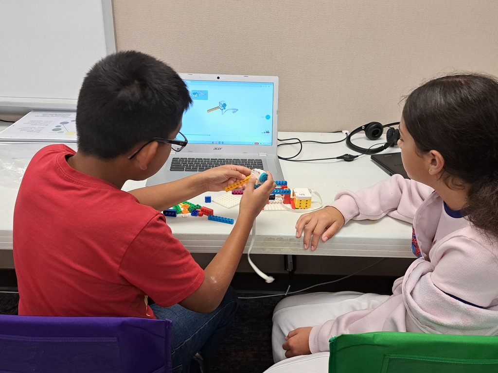 students working together to build Lego