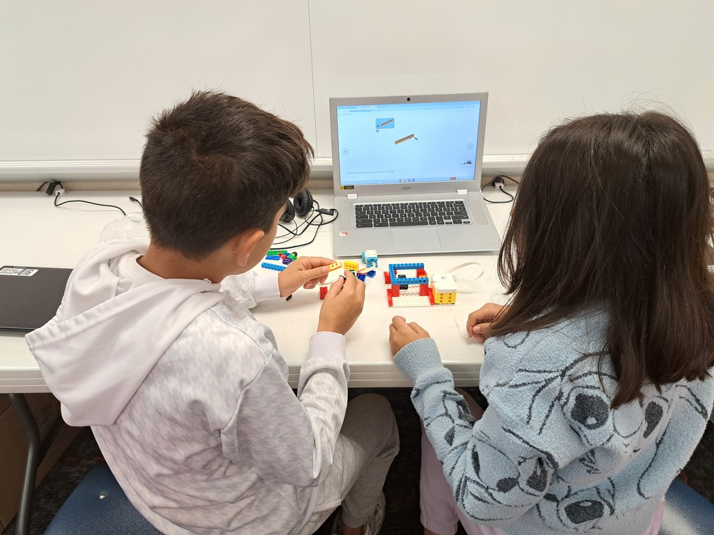 students working together to build Lego