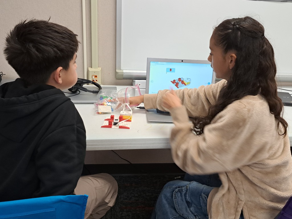 students working together to build Lego