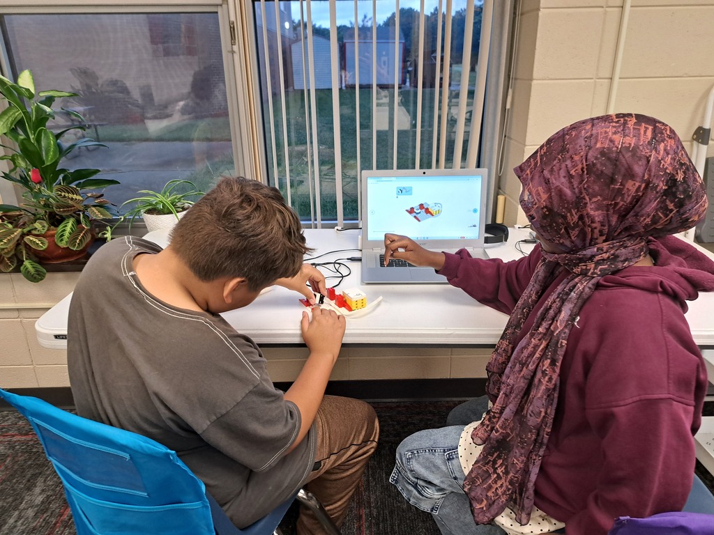 students working together to build Lego