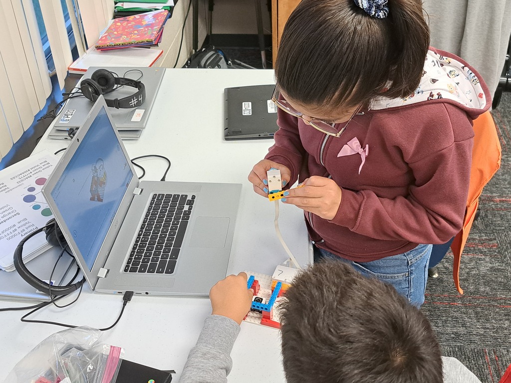 students working together to build Lego