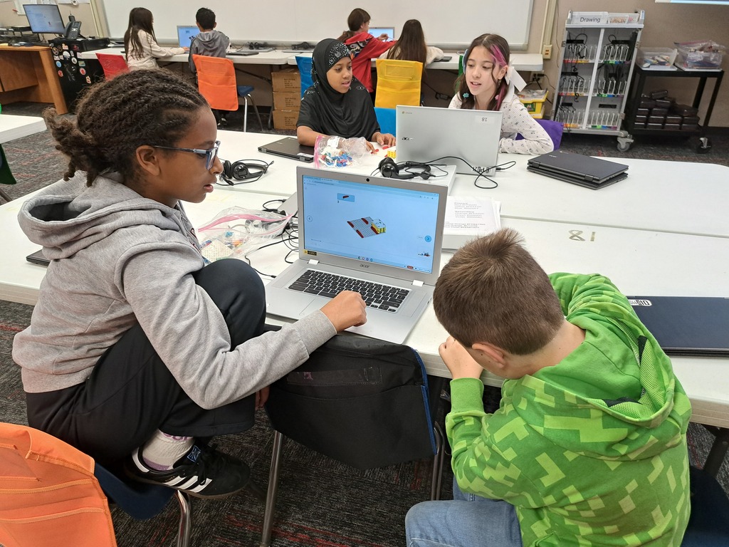 students working together to build Lego