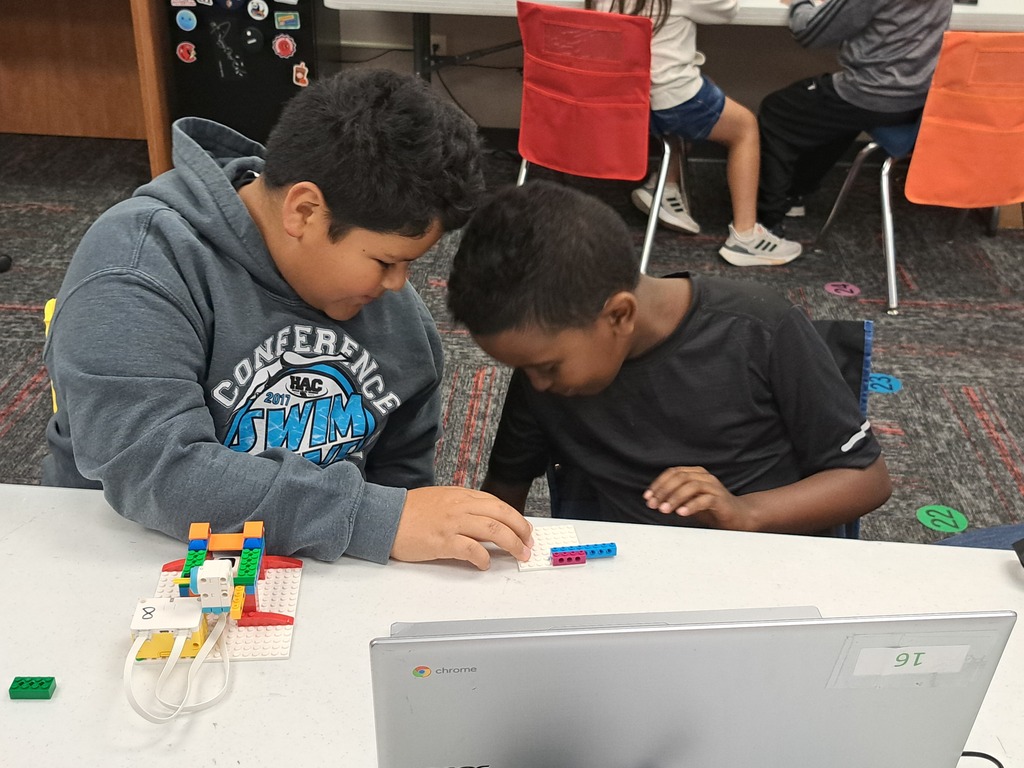 students working together to build Lego