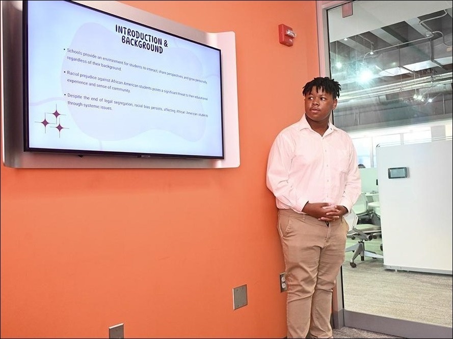 11th Grader Jahmere McDuffie from Academy Park High School gives his presentation "Learning While Black" Racial Bias Against African American Students in the Classroom" during the final day of S.C.O.P.E in the Krause Innovation Studio in Chambers Building on the University Park campus of Penn State University.