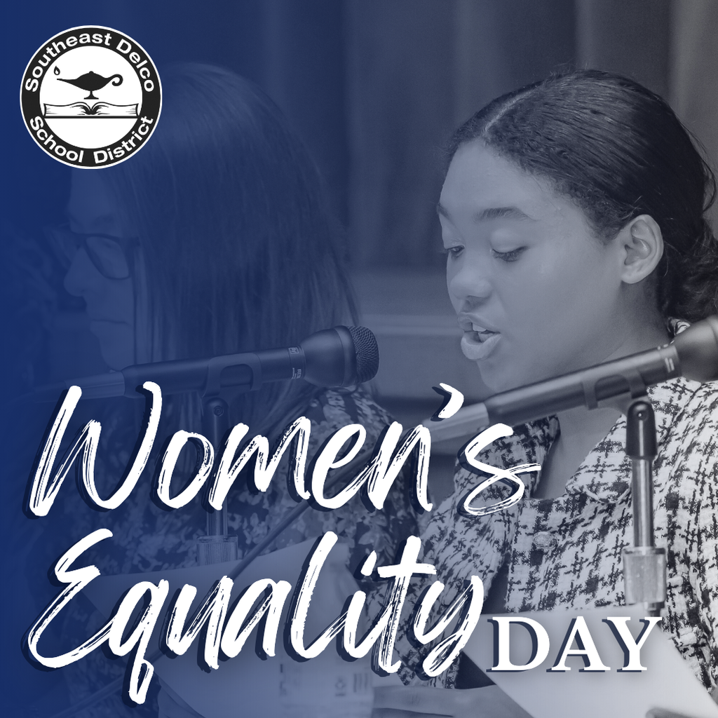 Blue-toned graphic featuring a young woman speaking into a microphone at a podium. Large white script text reads, “Women’s Equality Day.” In the top left corner is the Southeast Delco School District logo, showing a lamp above an open book.