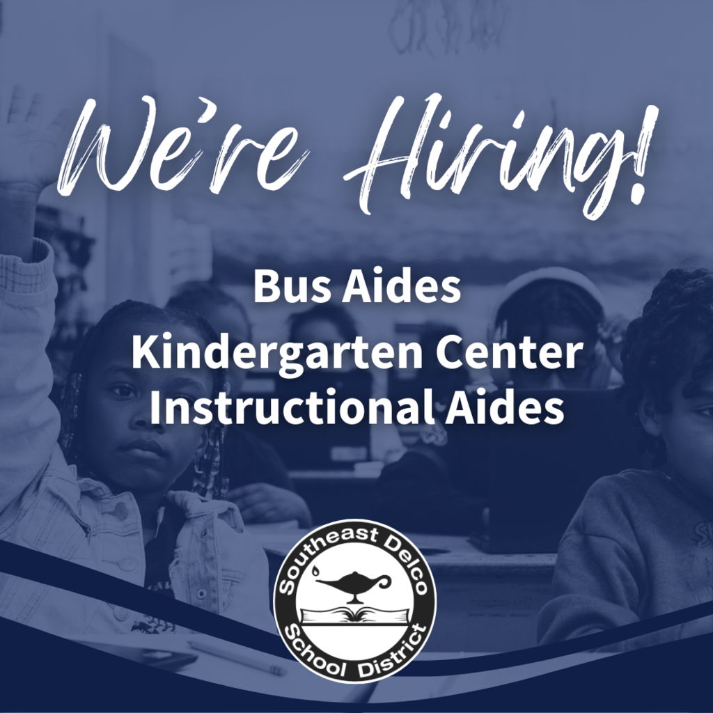 Blue-tinted graphic showing elementary students in a classroom. Large white text at the top reads: “We’re Hiring!” Below, text says: “Bus Aides, Kindergarten Center, Instructional Aides.” At the bottom is the Southeast Delco School District logo.