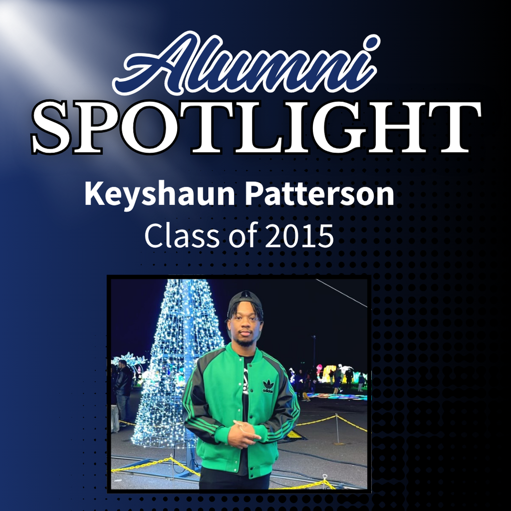 Graphic titled “Alumni Spotlight” with the name Keyshaun Patterson and “Class of 2015” below. A photo of Keyshaun Patterson standing in front of a large lit Christmas tree at night is displayed in the center. He is wearing a green Adidas jacket and a backward baseball cap against a dark blue background with a dotted design.
