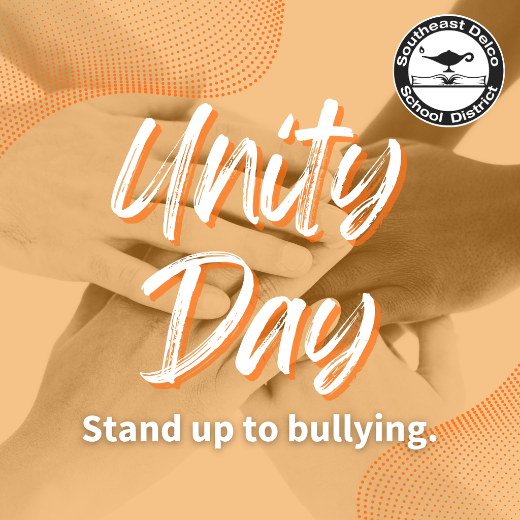 Graphic with an image of multiple hands stacked together in unity, overlaid with an orange tint. The Southeast Delco School District logo appears in the upper right corner. Large script text reads “Unity Day,” and smaller text below says “Stand up to bullying.”