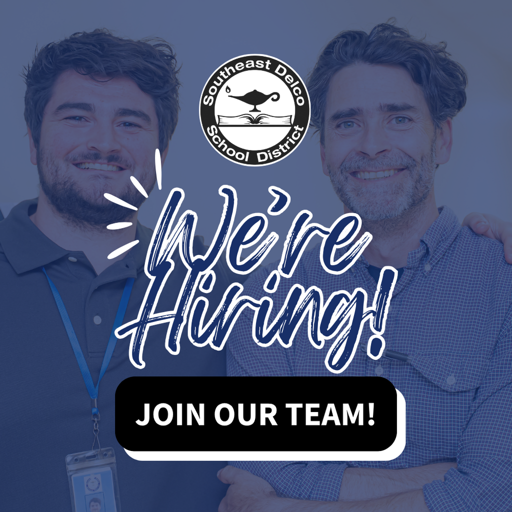 Two smiling staff members stand side by side, one with an arm around the other’s shoulder. The Southeast Delco School District logo appears above large text that reads “We’re Hiring!” followed by a black button that says “Join Our Team!”