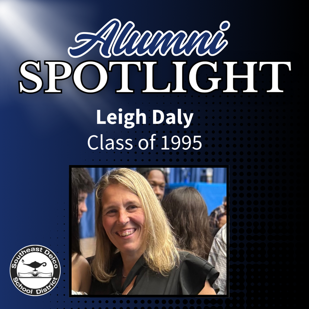A graphic titled “Alumni Spotlight” features Leigh Daly, Class of 1995. Below the text is a photo of Leigh Daly smiling while standing among other people. The background is a dark blue gradient with dotted accents, and the Southeast Delco School District logo appears in the bottom left corner.