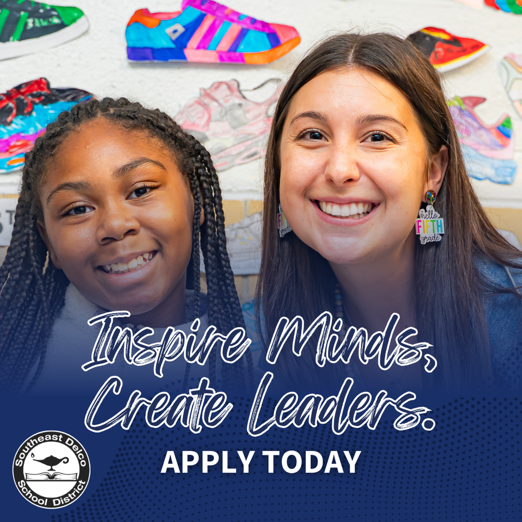 A teacher and student smiling in a colorful classroom with artwork and sneakers displayed on the wall behind them.