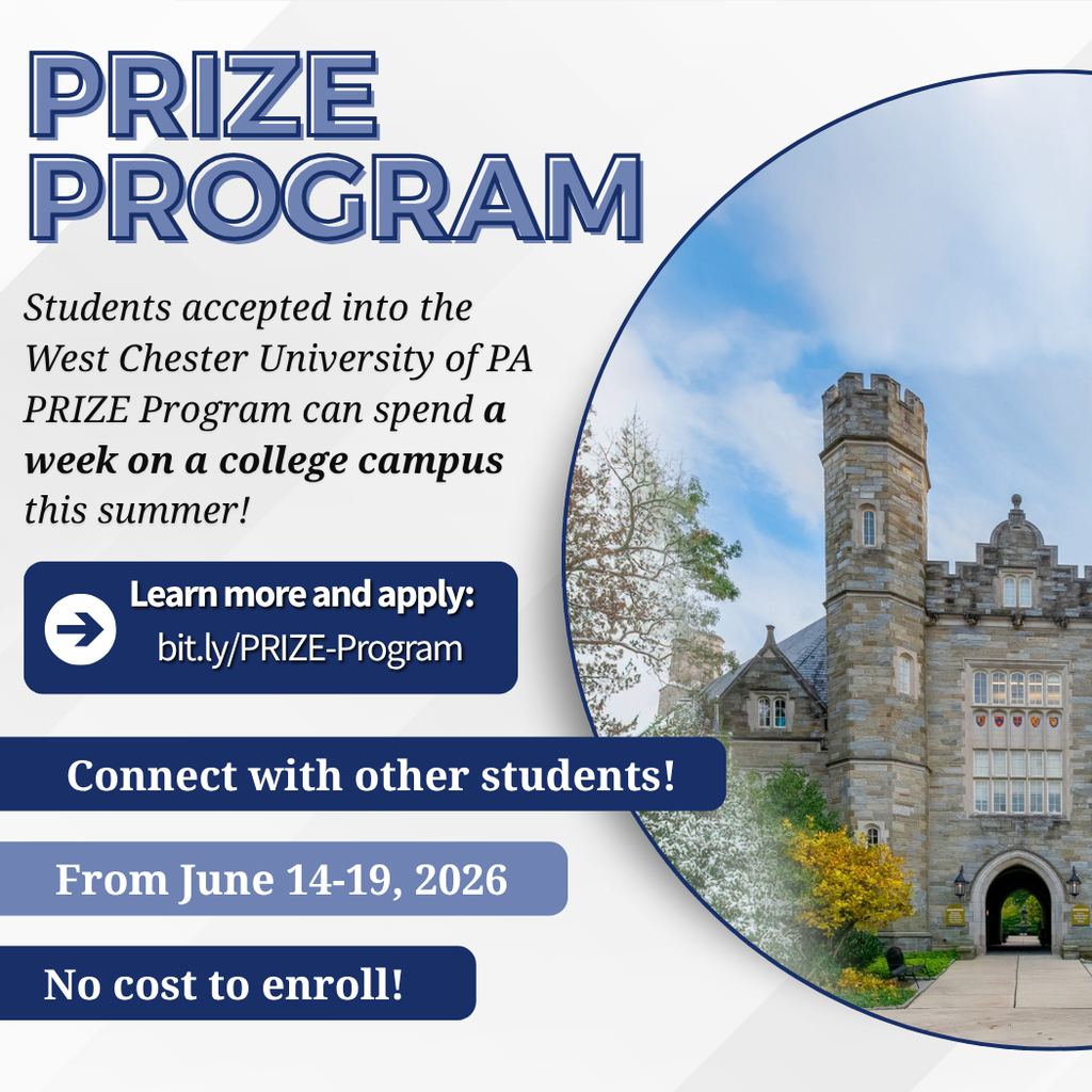 Historic stone building with towers at West Chester University campus under clear blue sky.