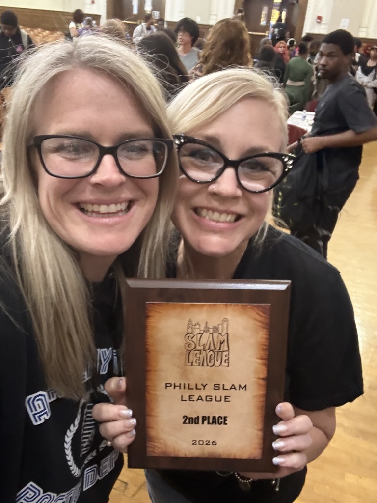 Two individuals holding a wooden plaque awarded for 2nd place in the 2026 Philly Slam League event.