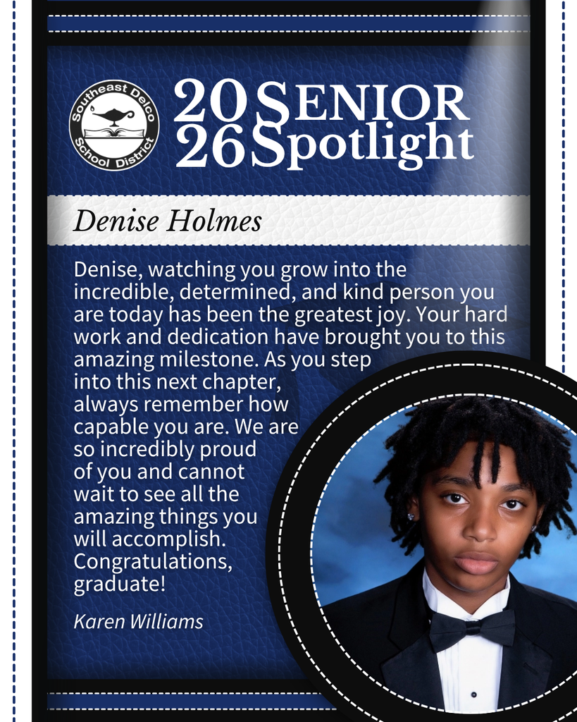 Senior spotlight photo featuring a student dressed in formal attire with a neat hairstyle and blue backdrop.