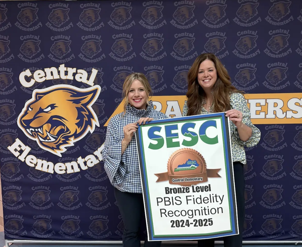 SESC Staff presenting a PBIS Fidelity Banner to Central Elementary staff