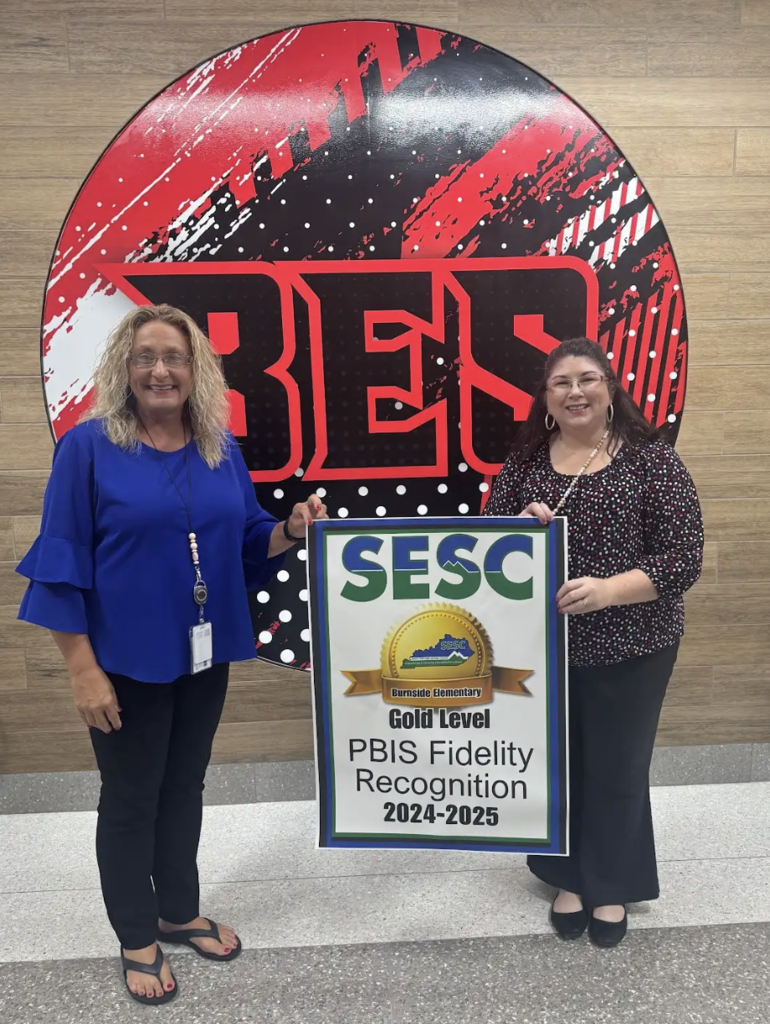 Burnside Elementary staff holding their PBIS Fidelity poster