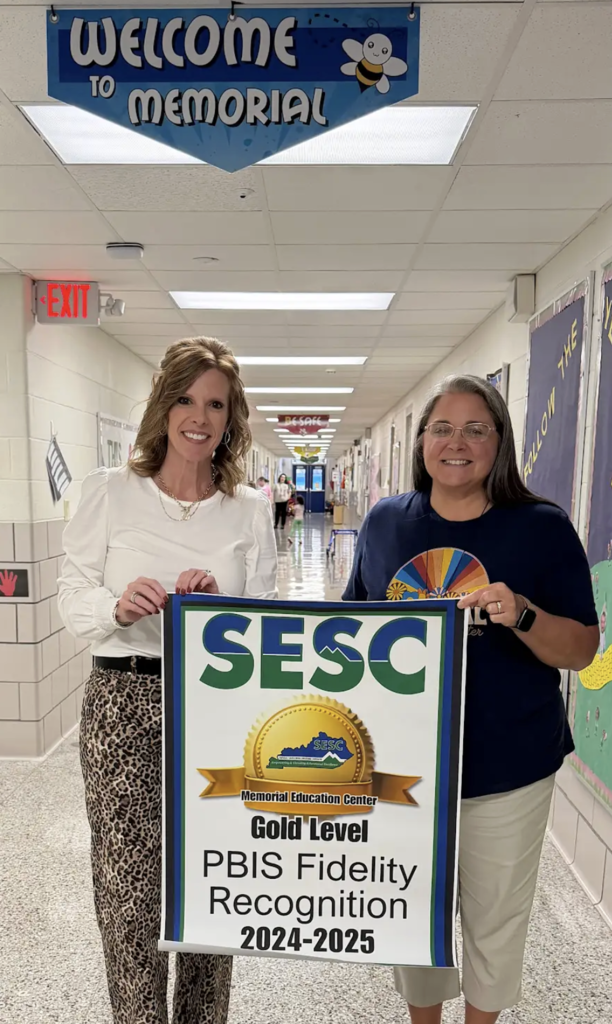 SESC presenting a Gold level PBIS Fidelity Recognition Banner to Memorial Education Center in Pulaski County