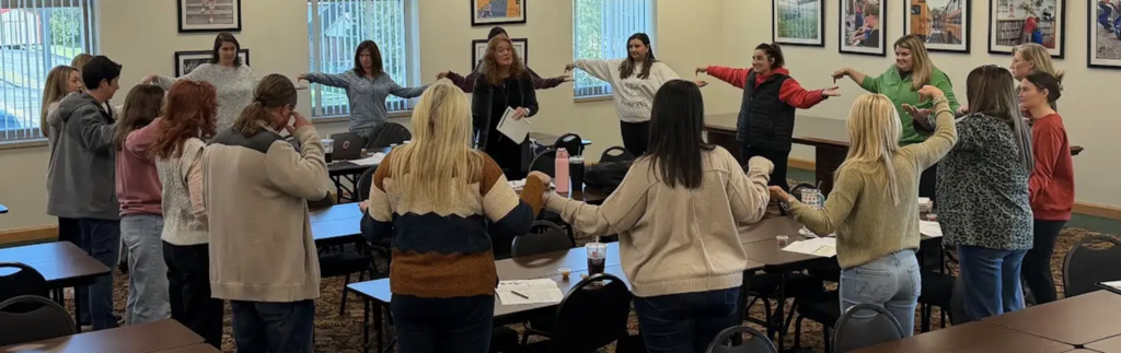 Teachers participating in an activity during a training