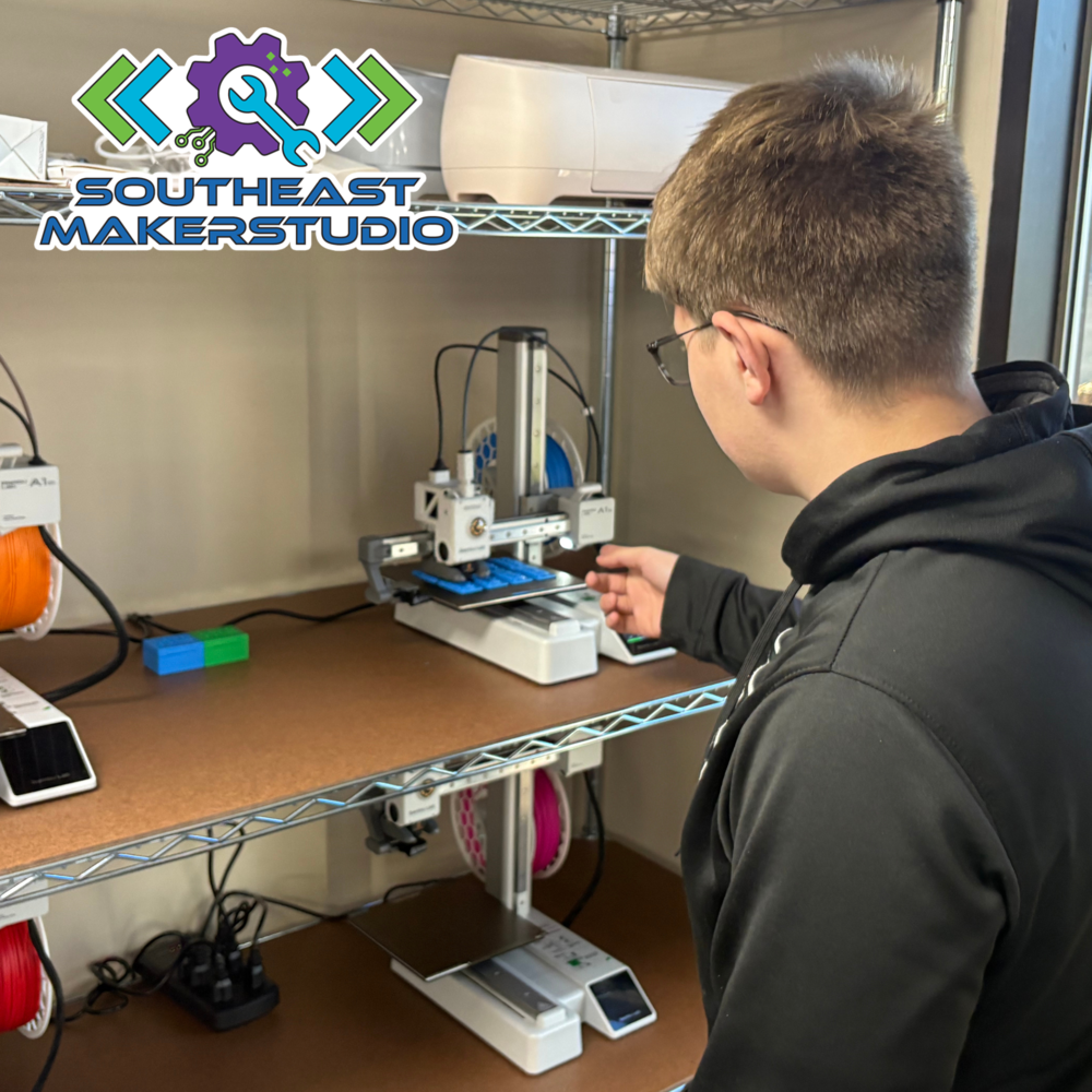 Student looking at 3D Printer in the SESC MakerStudio Logo