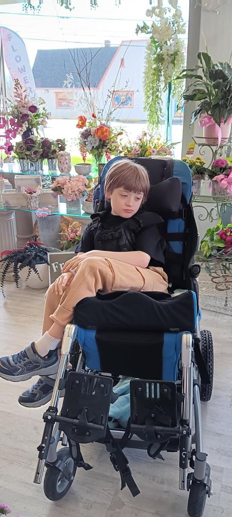 student in wheel chair surrounded by flowers