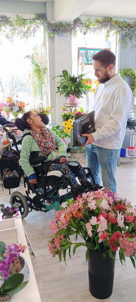 Student looking at the ipad in the flower shop