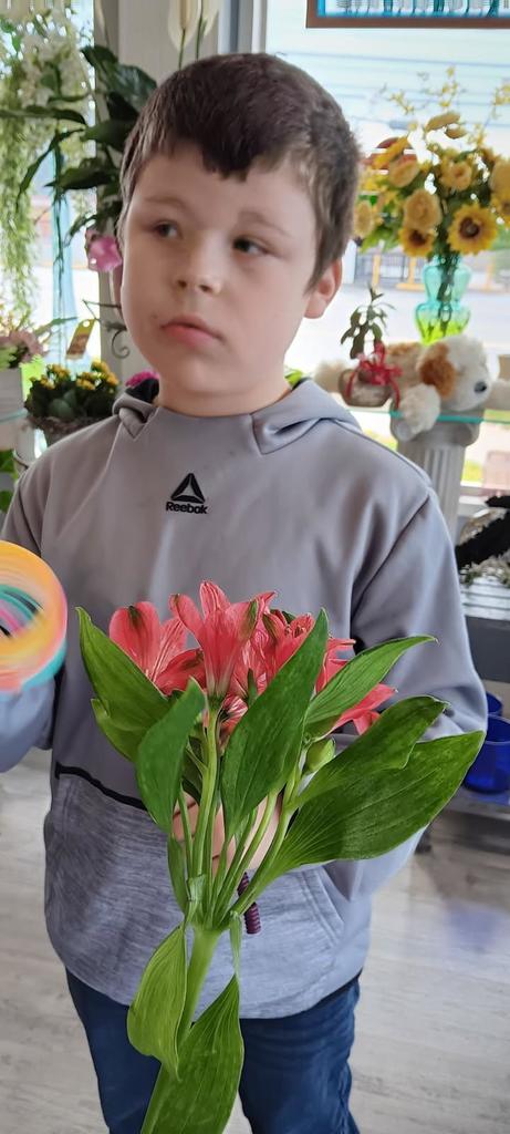 Student holding a bouquet of flowers