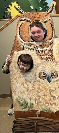 students in owl face cutouts