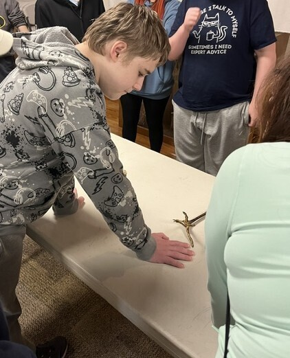 Student exploring items on table