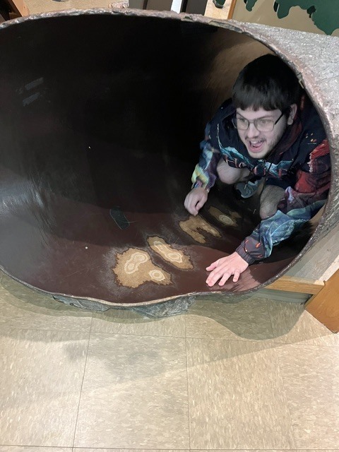 Student exploring a tunnel