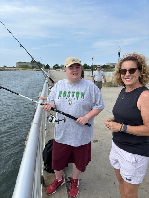 Teacher and students fishing off the pier