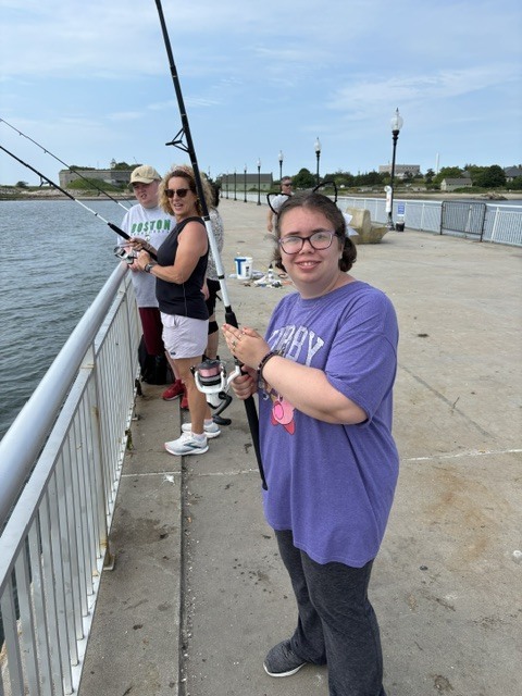 Teacher and students fishing off the pier